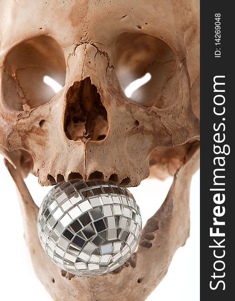 Human skull holding a disco ball in mouth, vertical photo. Human skull holding a disco ball in mouth, vertical photo