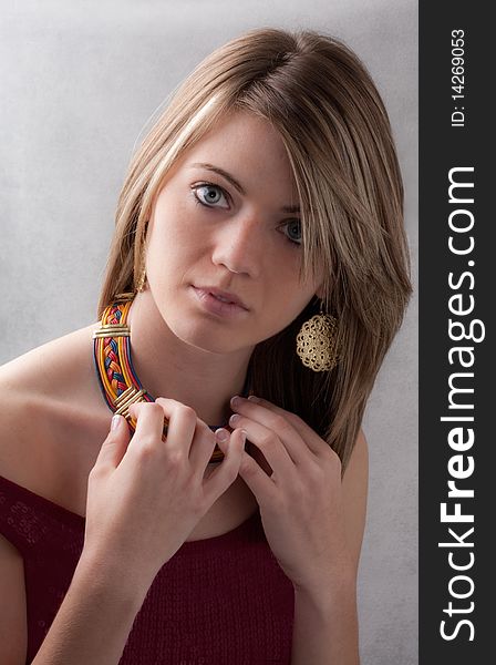 A head shot of a beautiful young woman wearing jewelry. A head shot of a beautiful young woman wearing jewelry