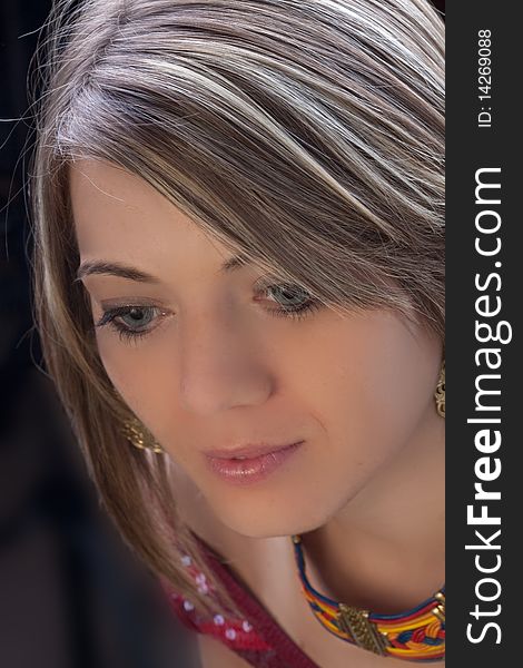 A close-up portrait, taken from above, of a pretty young woman's face. A close-up portrait, taken from above, of a pretty young woman's face