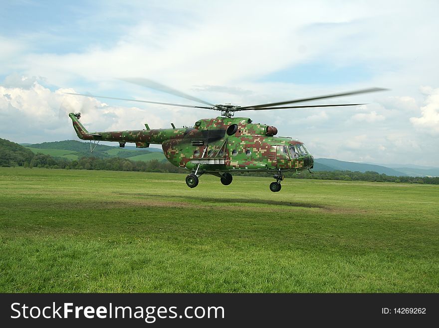 Camouflaged russian helicopter Mil Mi. taking off,. Camouflaged russian helicopter Mil Mi. taking off,