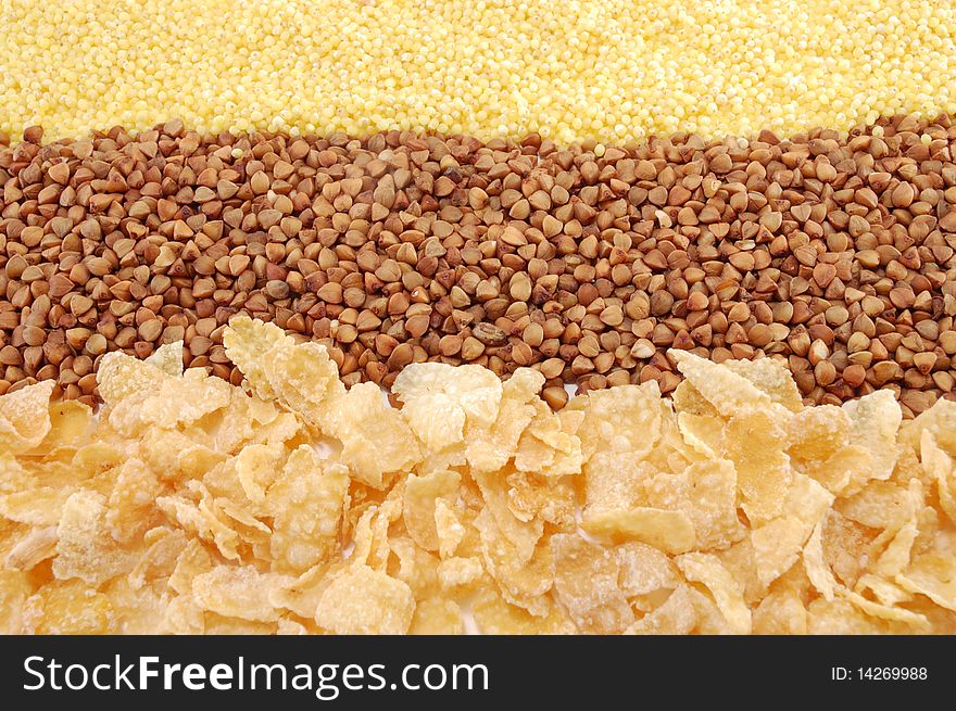 Three cereals (buckwheat, millet, corn flakes) isolated on a white background. Three cereals (buckwheat, millet, corn flakes) isolated on a white background