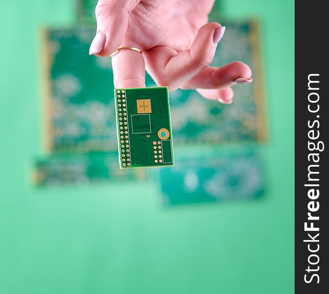 Small Electronics Circuit Boards on human woman finger. The woman technician hand. The concept of computer, service, electronics, hardware, repairing, upgrade and technology. Small Electronics Circuit Boards on human woman finger. The woman technician hand. The concept of computer, service, electronics, hardware, repairing, upgrade and technology.