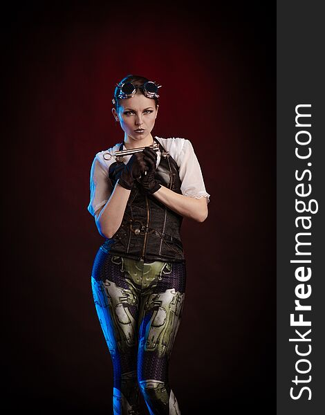 Emotional woman in steampunk costume posing in blue and red stage light