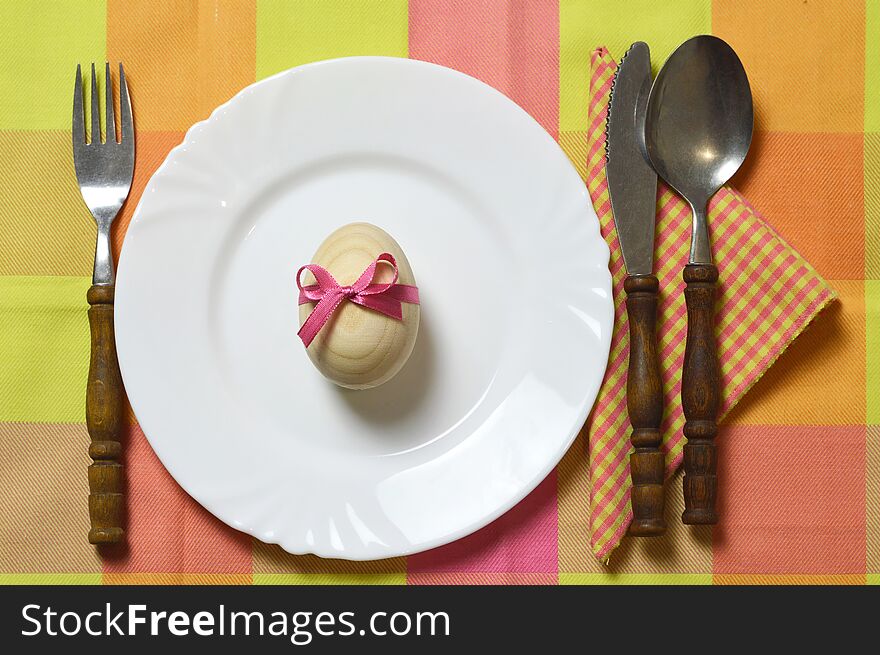 Easter table setting. Top view of Easter egg, plate and cutlery. Easter table setting. Top view of Easter egg, plate and cutlery