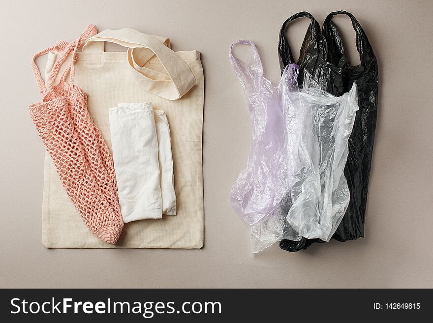 Set for free plastic shopping and packaging - cotton bags and string bag versus plastick pack. Zero waste modern trendy concept