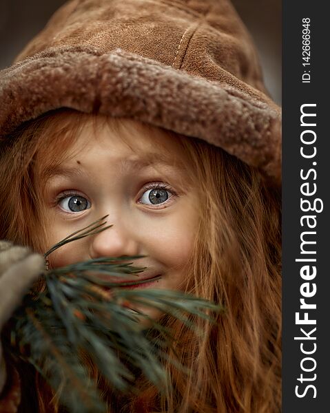 Cute little girl portrait close up in a hood at cloudy spring day. Cute little girl portrait close up in a hood at cloudy spring day