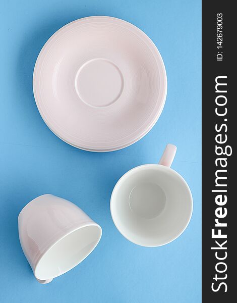 Kitchen, dishware and drinks concept - Empty cup and saucer on blue background, flatlay