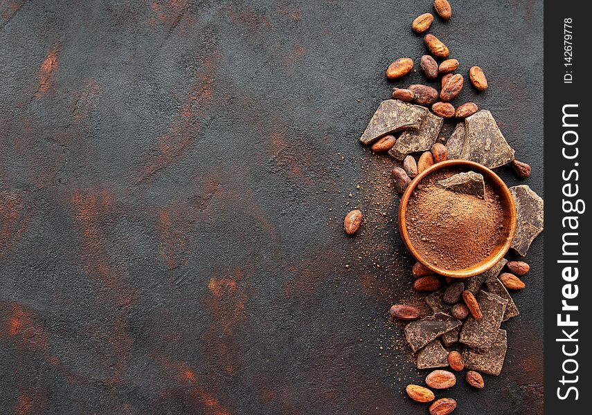 Natural  cocoa powder and cocoa beans  on a black background. Natural  cocoa powder and cocoa beans  on a black background