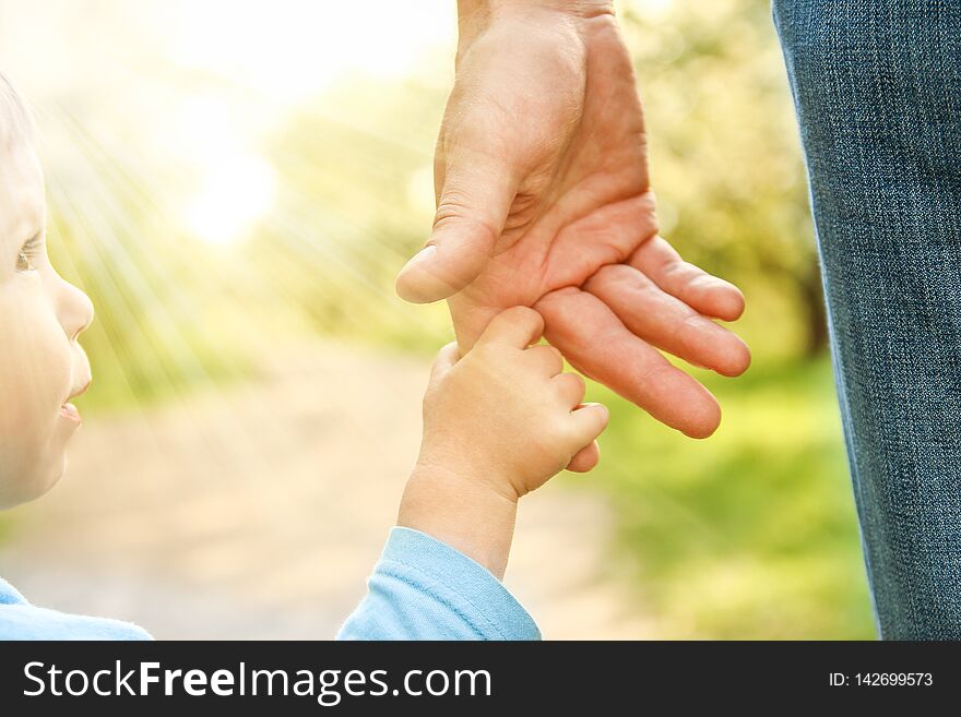 The Parent Holding The Child`s Hand With A Happy Background