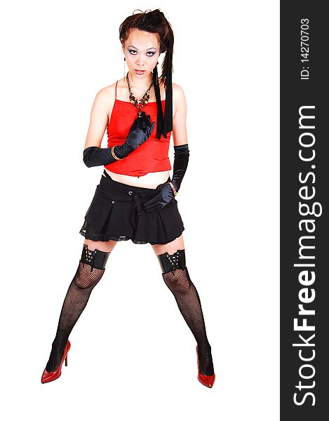 Pretty Asian punk girl in black stockings and short skirt with a red top and black cloves and red high heels, for white background. Pretty Asian punk girl in black stockings and short skirt with a red top and black cloves and red high heels, for white background.