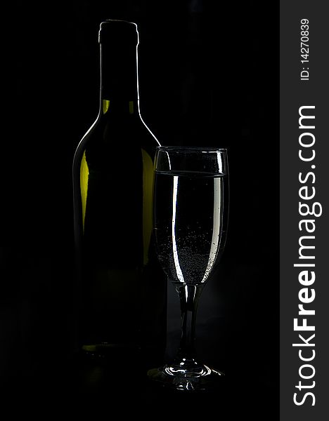 Shot glass of wine and a black background