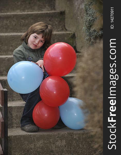 Happy young girl with balloons outdoor