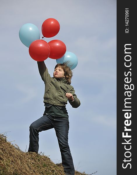 Happy young girl with balloons outdoor