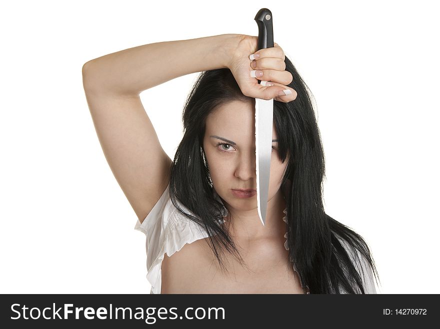 Young woman holds knife in face isolated in white