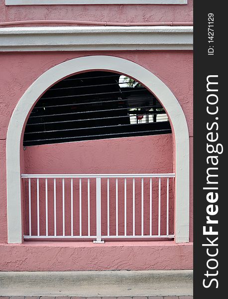 Very nice design parking garage with arch and a colorful vibrant pink. Very nice design parking garage with arch and a colorful vibrant pink