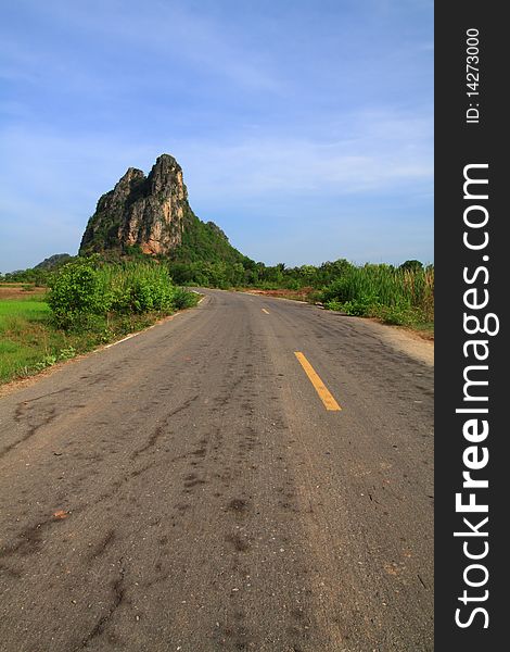 This rural road straight to big mountain with blue sky. This rural road straight to big mountain with blue sky.