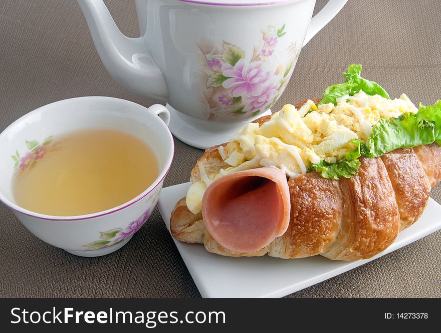 Croissant with egg mayonnaise, egg bits and ham. Croissant with egg mayonnaise, egg bits and ham