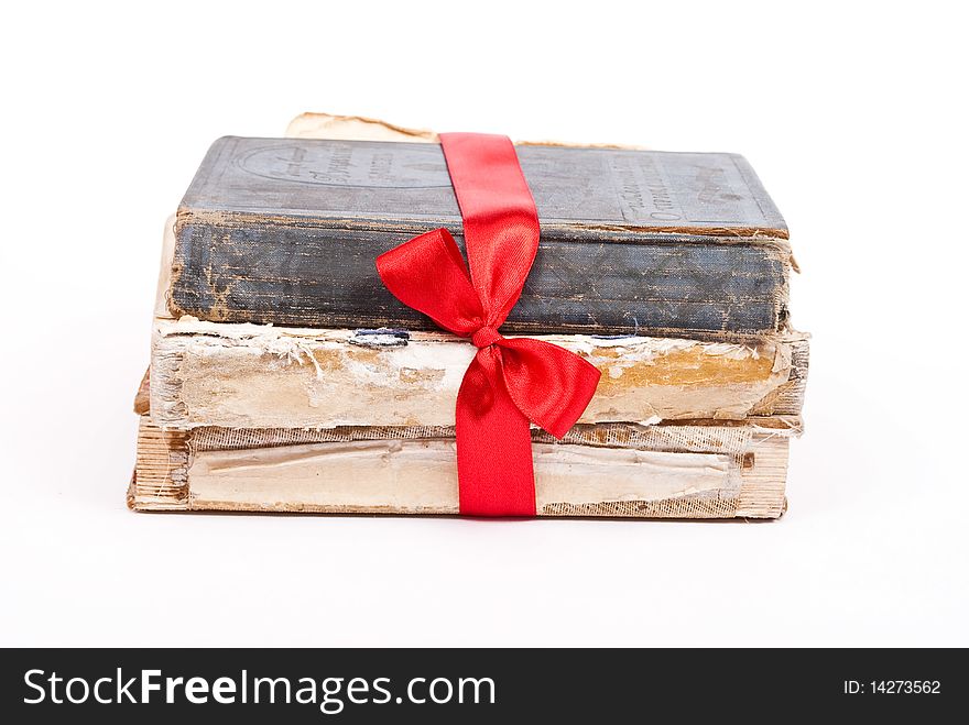 Pile of books with red ribbon and bow