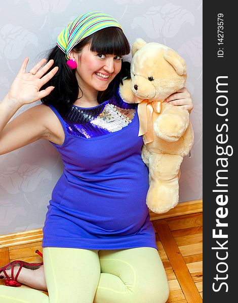Pregnant female with bear toy