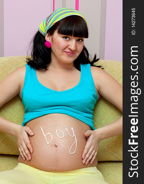 Pregnant female on yellow sofa