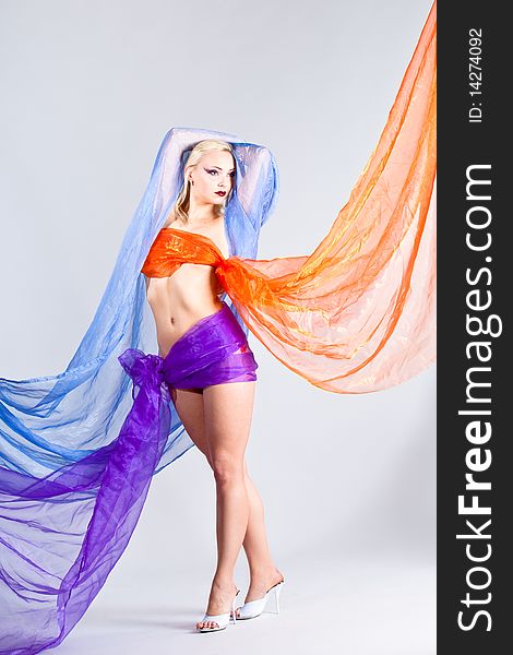 Beautiful young woman wraped in colorful tulle as bikini, vertical shot