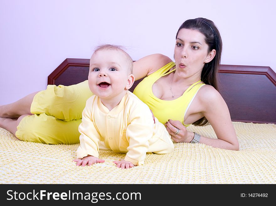 Mother and child play on the bed