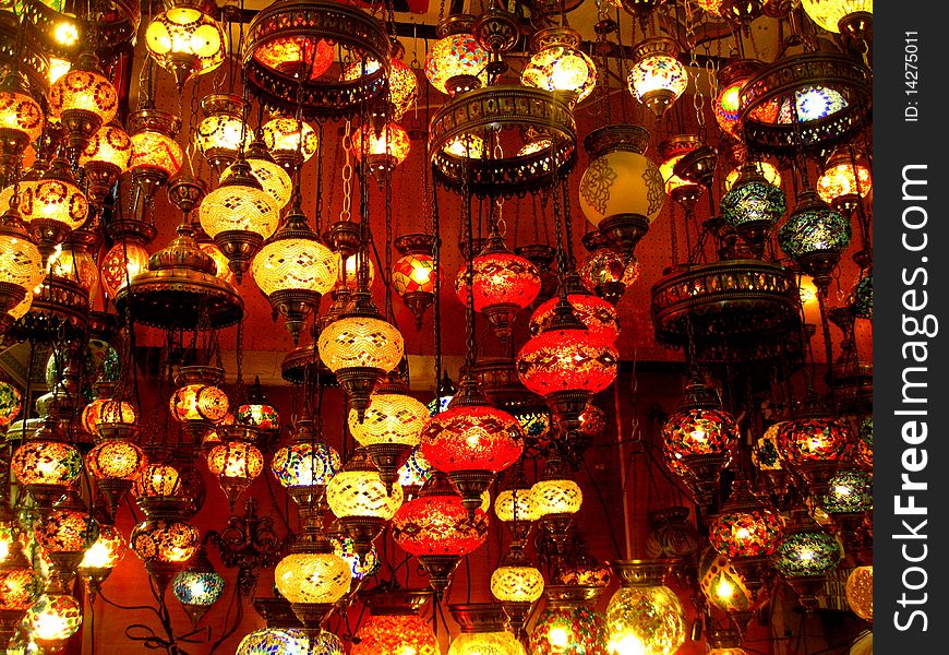 Different colourful lamps hanging from the ceiling