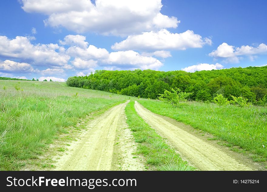 Earthen road in the middle of field. Earthen road in the middle of field