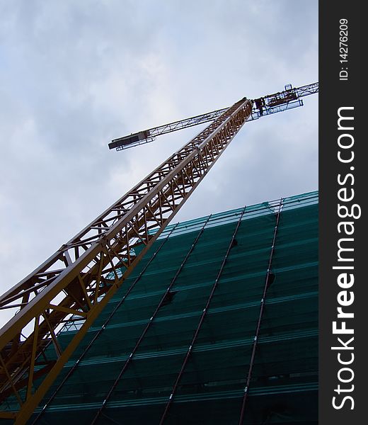 Crane working against cloudy sky on a residential building site 

*with space for text (copyspace)
**RAW format available at request. Crane working against cloudy sky on a residential building site 

*with space for text (copyspace)
**RAW format available at request
