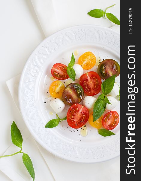 Caprese salad with mozzarella, tomatoes and fresh basil