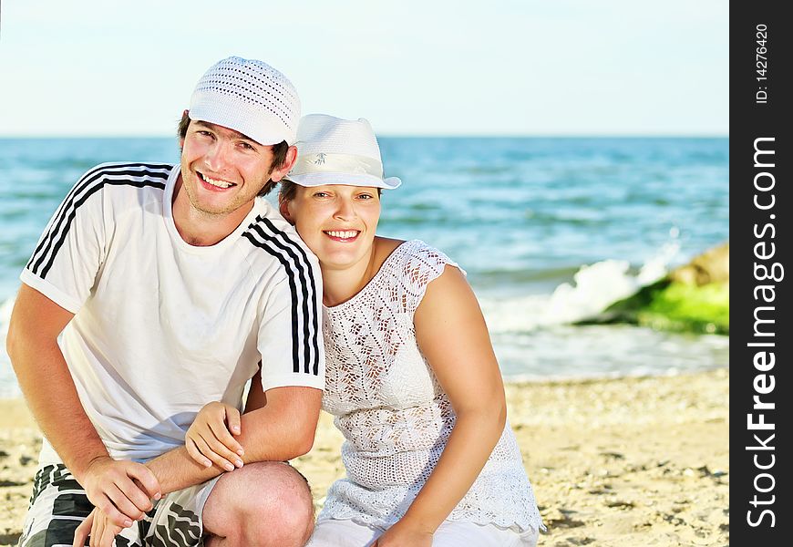 Smiling man and woman against a sea background. Smiling man and woman against a sea background