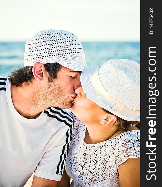 Kissing man and woman against a sea background. Kissing man and woman against a sea background