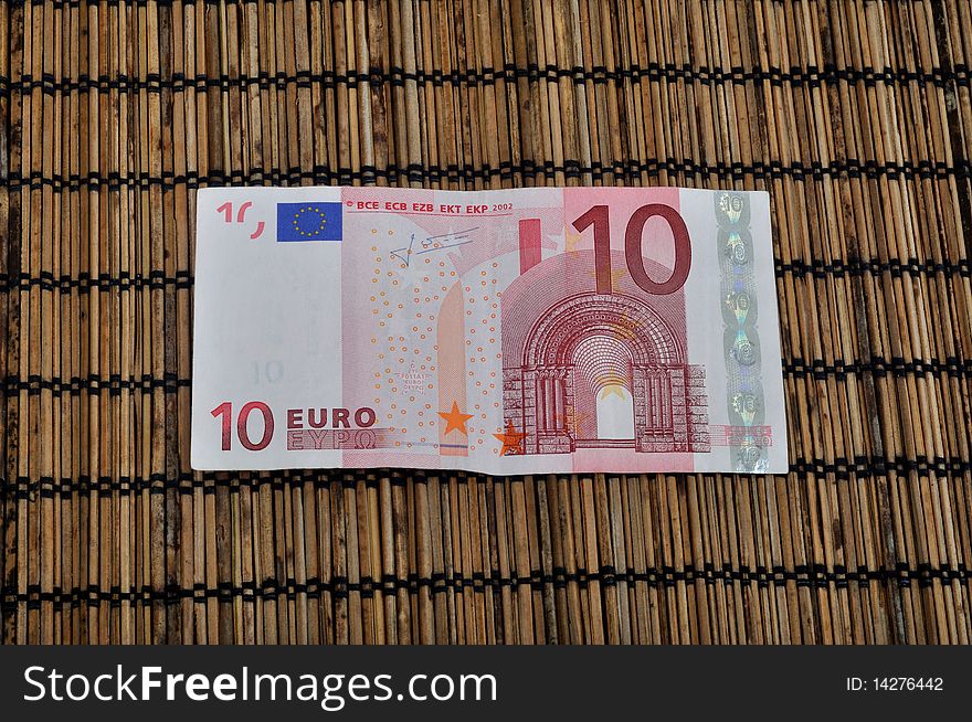 Ten Euro currency on bamboo background