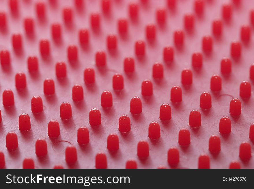 Red plastic pattern background macro shot (blurred background)