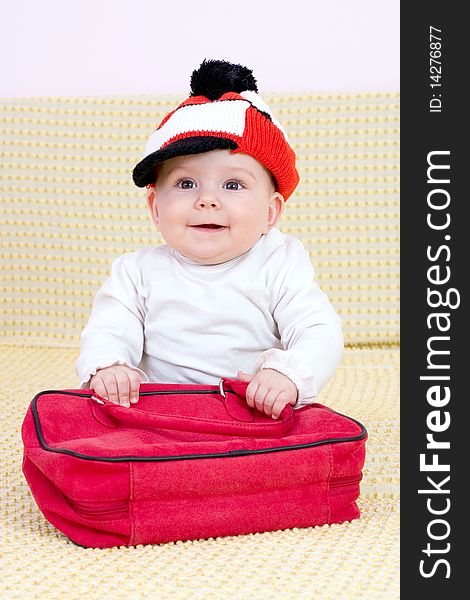 Kid in red hat and bag