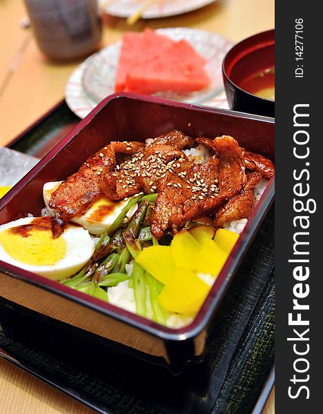 Japanese bento box with rice and grilled black pork. Japanese bento box with rice and grilled black pork