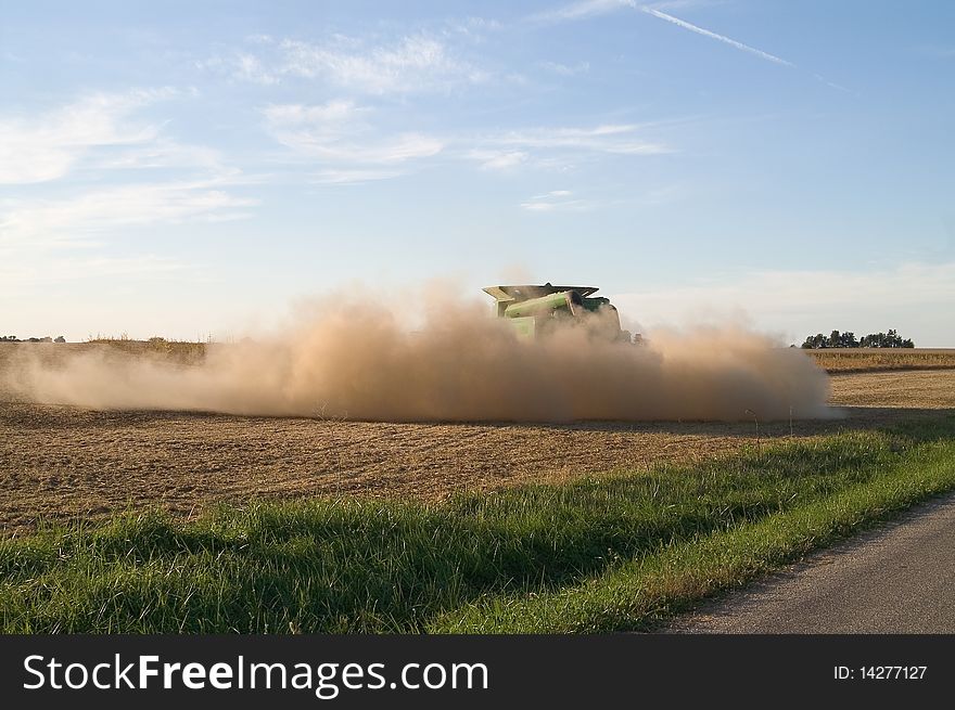 Dust from a combine fills the air. Dust from a combine fills the air