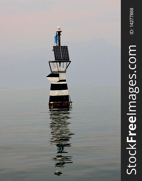 Beacon with the Madonna in lake