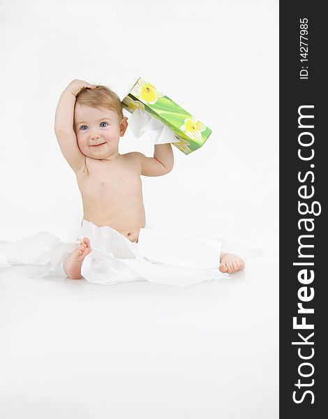 Infant plaies with box napkin on egg white background. Infant plaies with box napkin on egg white background.