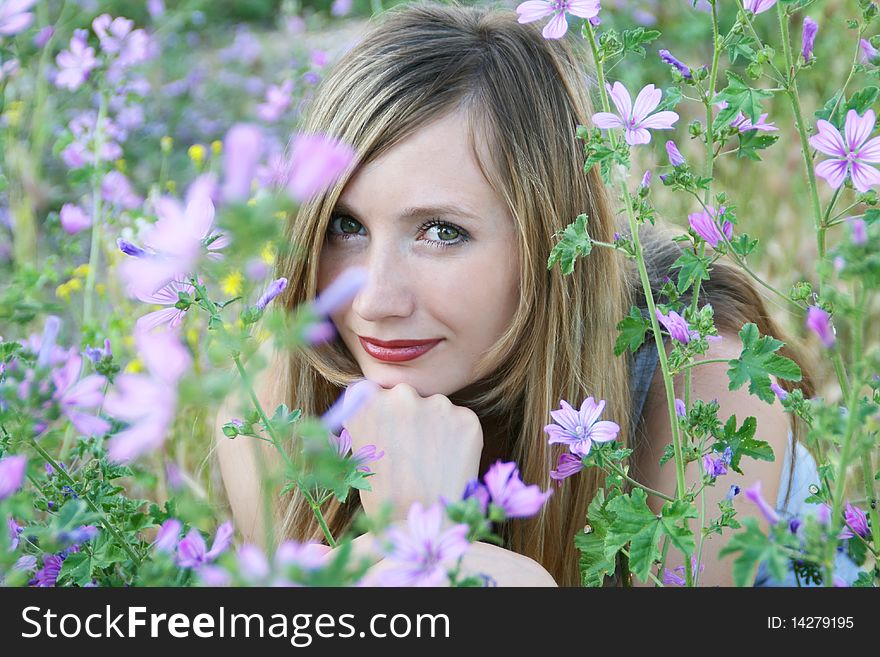 Portrait of happy girl in violet flowers. Portrait of happy girl in violet flowers