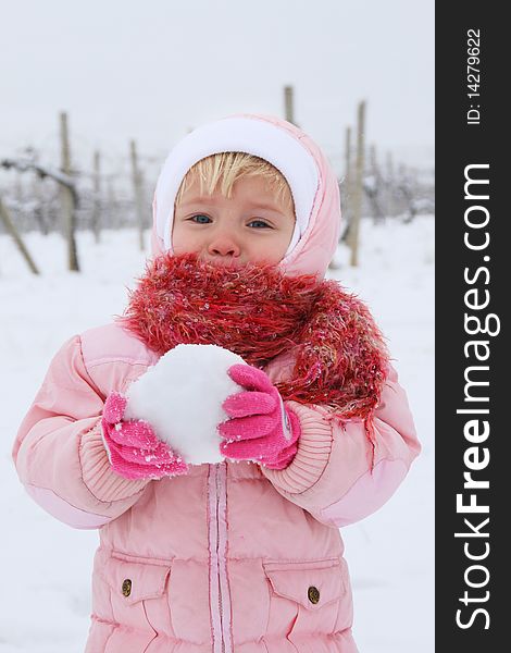 Pretty girl making a snowball