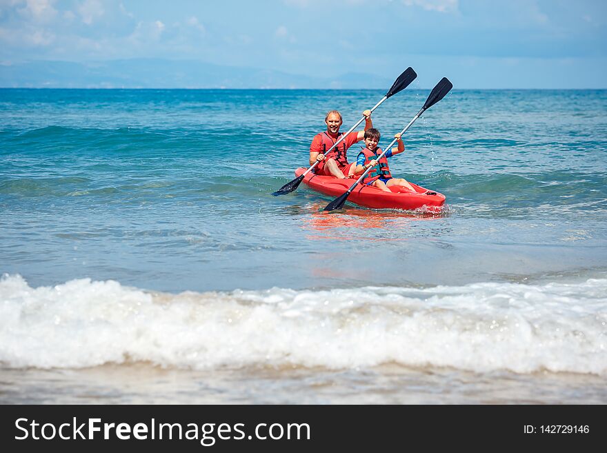 Father and son kayaking in ocean. Active vacation with young kid. Holiday activity with schoolboy child. Family summer fun