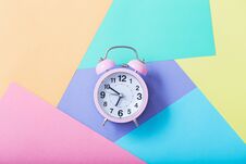 Alarm Clock On Pastel Paper Background Stock Photos