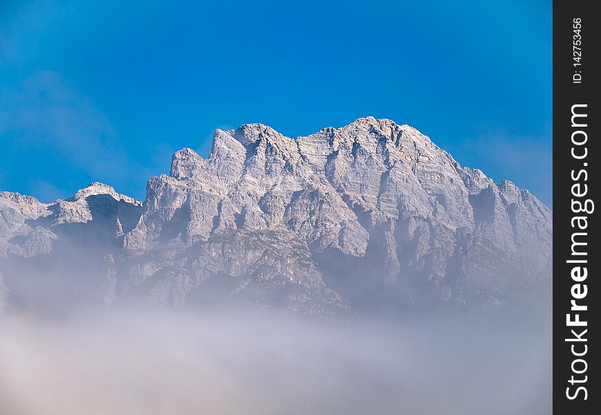 Image of mountain peak with clouds in the alps