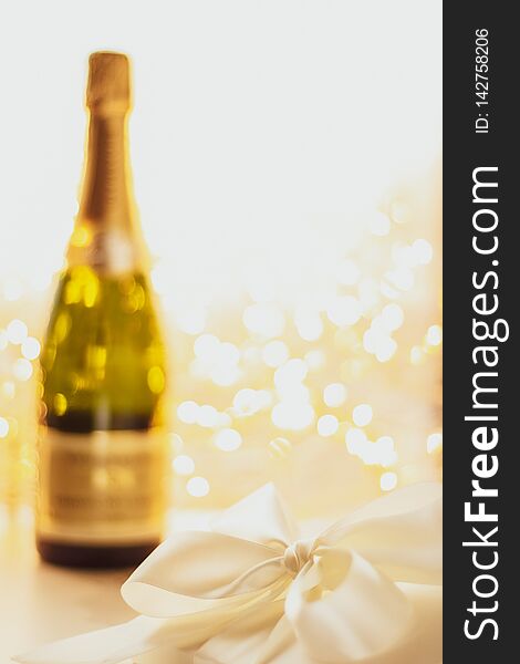 Romantic celebration, lifestyle and luxury present concept - The bottle of champagne and holiday gift box