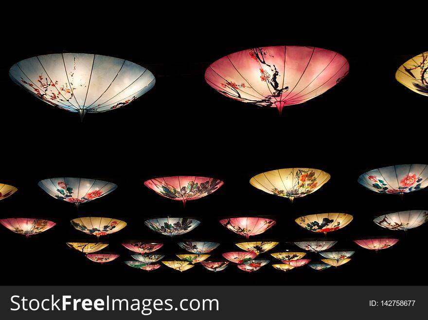 Chinese lanterns installation with hanging umbrellas