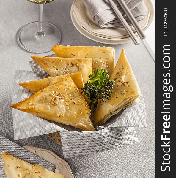 Puff pastry triangles stuffed with cheese, typical from Greece. Puff pastry triangles stuffed with cheese, typical from Greece