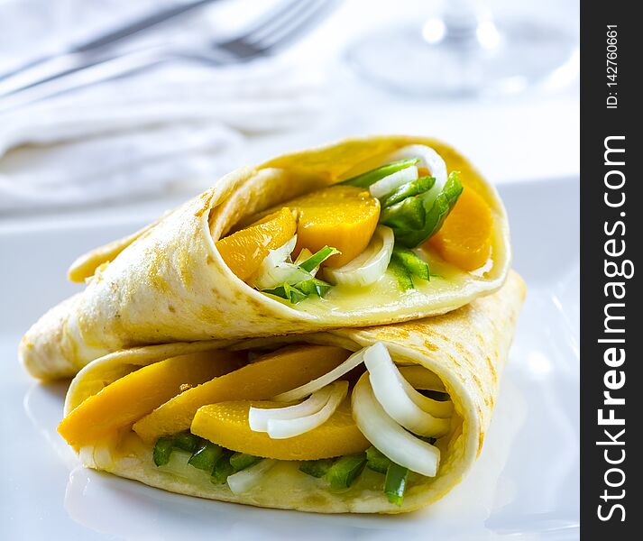 Delicious vegetarian wrap with fruit, vegetables and cheese. Delicious vegetarian wrap with fruit, vegetables and cheese