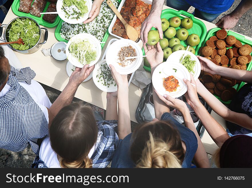 Volunteers Serving Food For Poor People