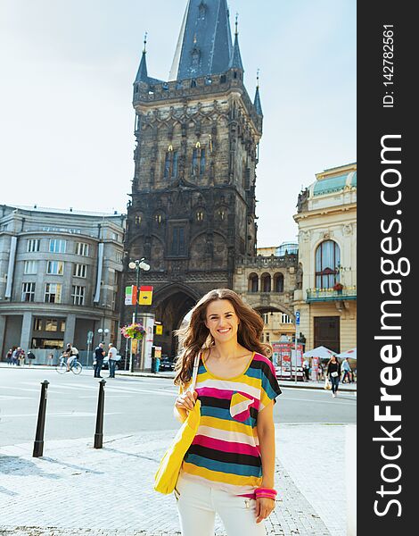 Portrait of smiling modern solo traveller woman in colorful striped t-shirt near Powder Tower in Prague Czech Republic. Portrait of smiling modern solo traveller woman in colorful striped t-shirt near Powder Tower in Prague Czech Republic